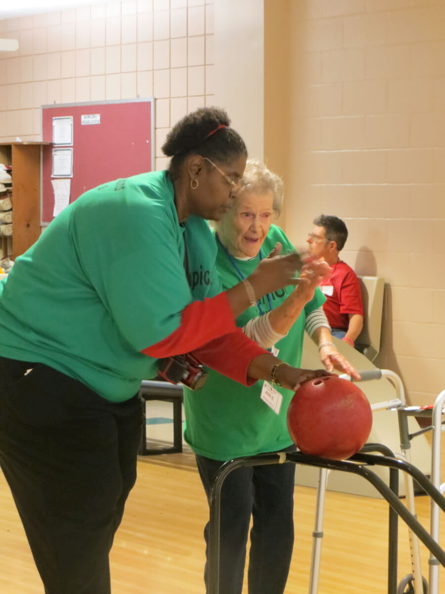  Westwood Commons Activities Director Cathy Toney assists resident Ann Bell in a game of bowling