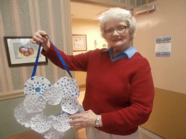 Twelve Oaks resident Brenda Edmonds displays her snowflake wreath
