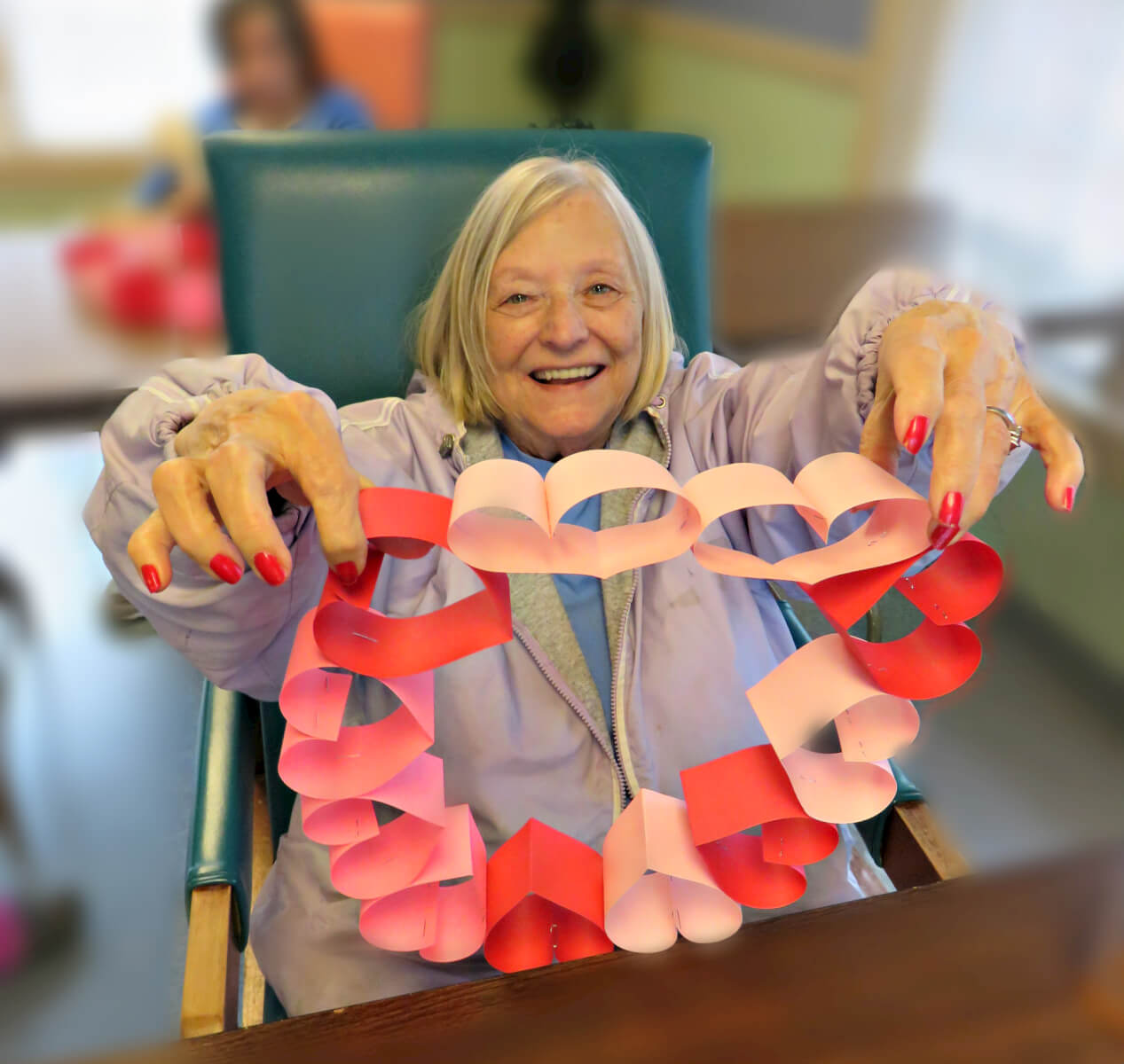 Twelve Oaks resident Eva Briggs shows off her homemade Valentine’s Day heart wreath