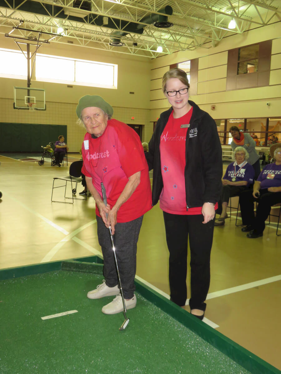 Woodcrest Commons assisted living resident Agnes Biront competes in putt-putt golf along with Case Manager Ginger Brokaw