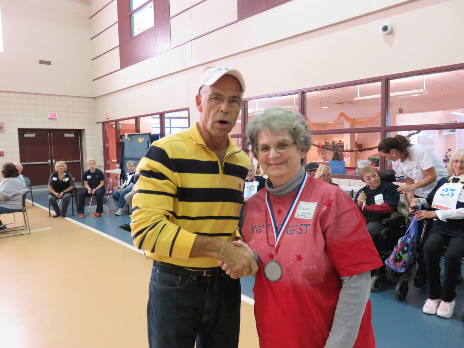 Rosanne Bourne receives a medal from DePaul’s Recreation Supervisor Dan Charcholla
