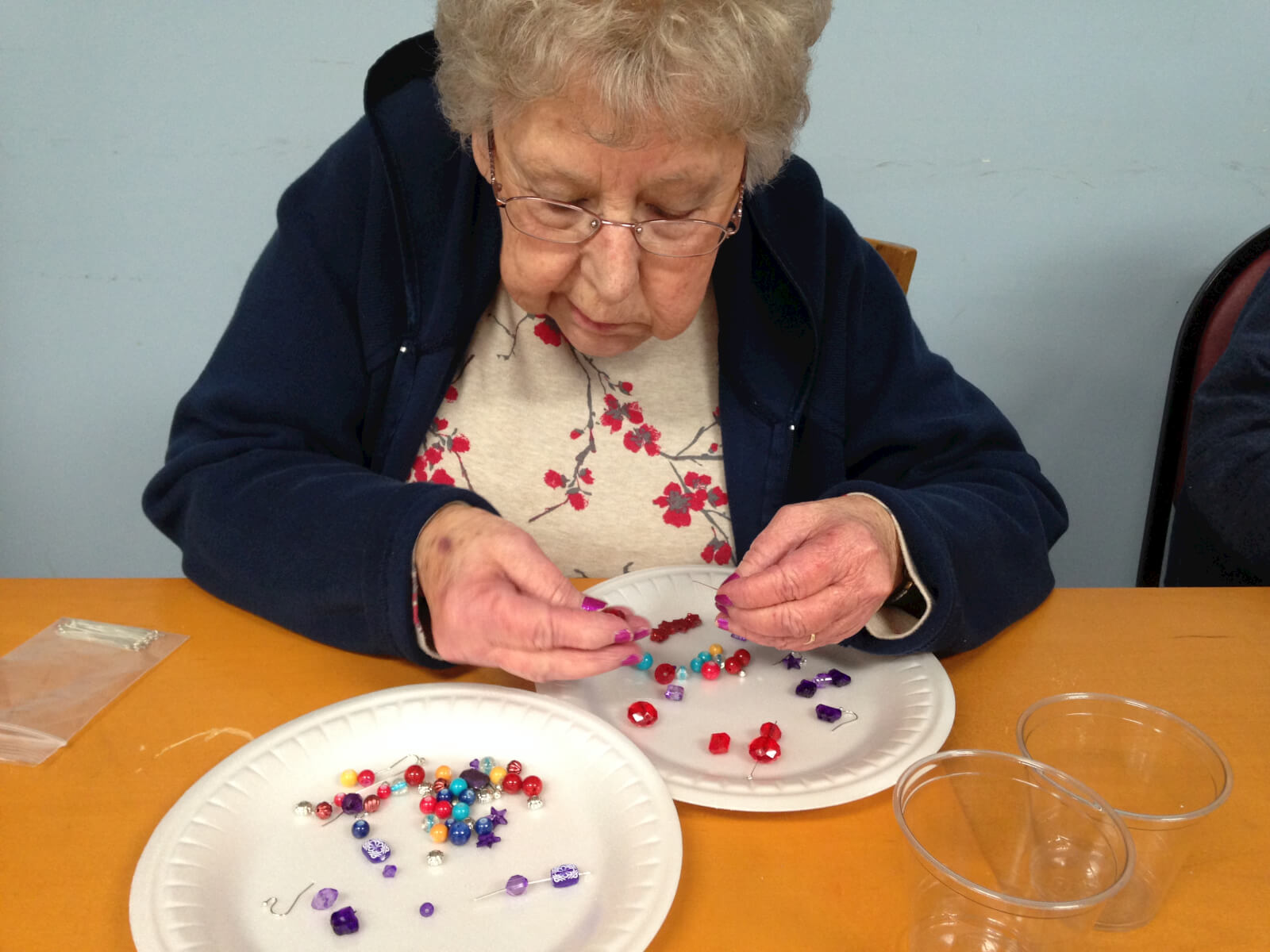 Southfork resident Libby Carter concentrating on threading beads onto the needle