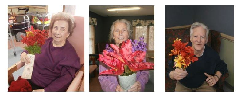 Twelve Oaks residents Anna Thompson, Latrice Hiatt and Gene Lowe show off the flower arrangements they created for their room.