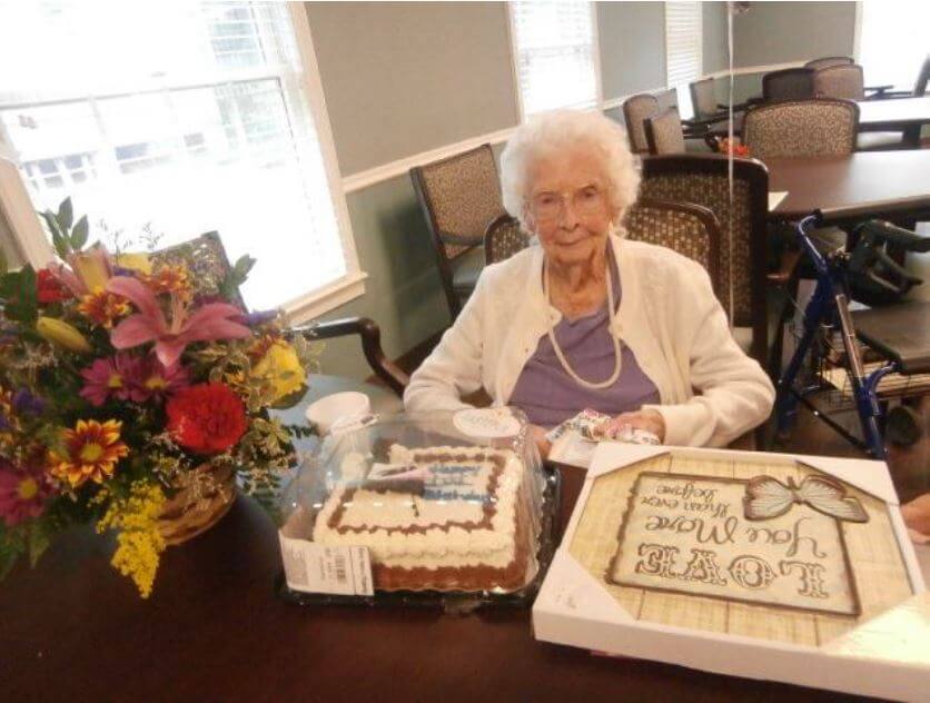 Annie Riggs celebrating her 101st birthday with cake, flowers and gifts