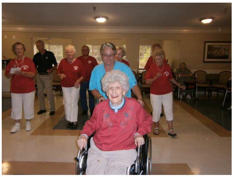 Cambridge House resident Helen Byers joins in line dancing fun with assistance from Dietary Manager Sherry Arran