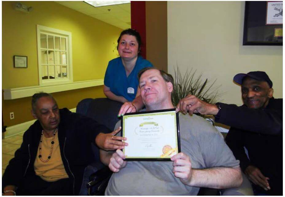  Woodridge residents Jackie Massey, Med Tech Melissa Ellis Tom Rich and Doug Mills posing with the Caring.com award