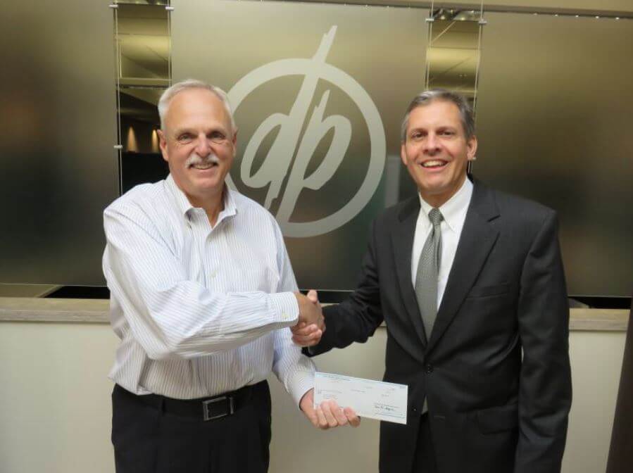 Vice President of Commercial Real Estate for First Niagara John Berry presents a grant to DePaul President Mark Fuller 