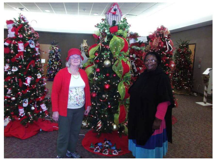 Greenbrier assisted living residents posing with a Christmas tree