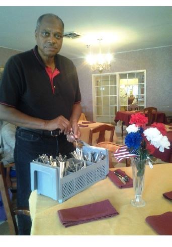 Heath House Resident Keith Smyre setting up silverware