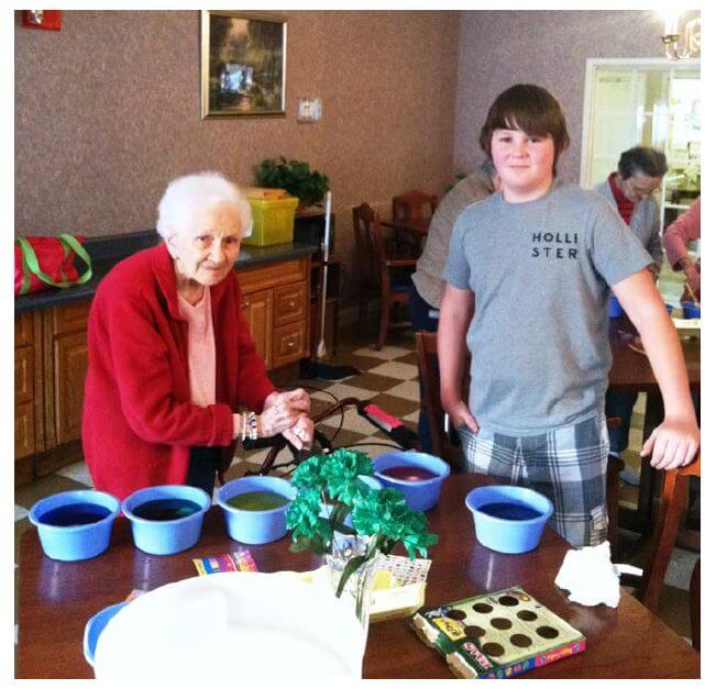 Heath House resident Leila Carpenter and visitor Houston Hall coloring Easter eggs.