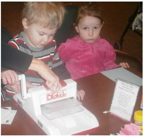 Little Lambs preschoolers Kyle Foley and Emileigh Zagata work on a snowman craft project with seniors at Horizons