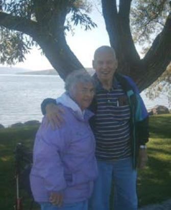 Horizons residents Paul and Helen Guadagna posing in front of a lake present day