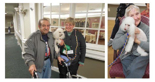 Pee Dee Gardens resident Joe Reino with Baldwin-Moore and resident Pat Kale holding one of the pet therapy dogs