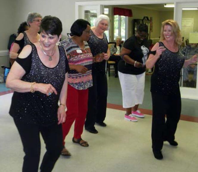 Sassy Steppers dancing with staff and residents of Woodridge assisted living