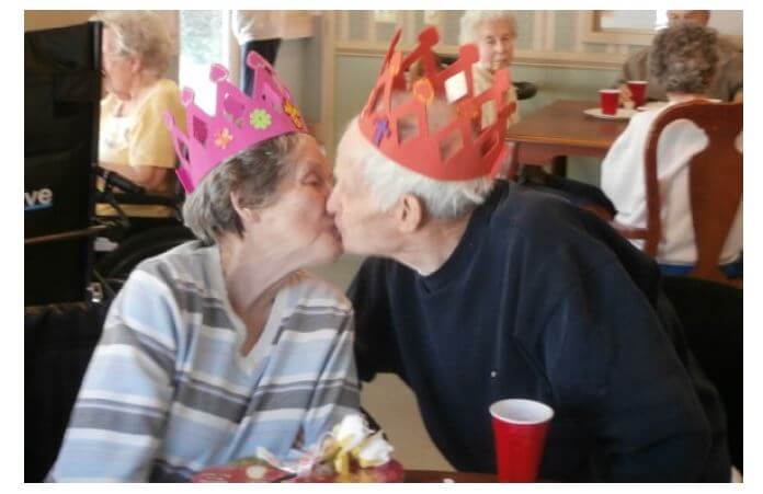 Twelve Oaks residents Barbara and Randall Norris share a kiss on valentine's day