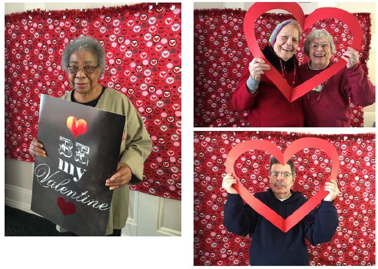 Woodcrest Commons residents Bernece Dorrough, Barb Frielinghaus and Barbara Shaver and Doug Kurlan posing for the camera in a photo booth with valentine's day props 