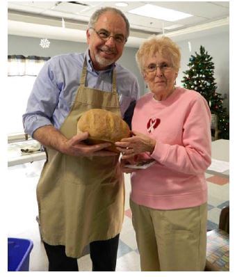 Chad Fery and one of his bread loaves with Woodcrest Commons resident Joanne Hackett