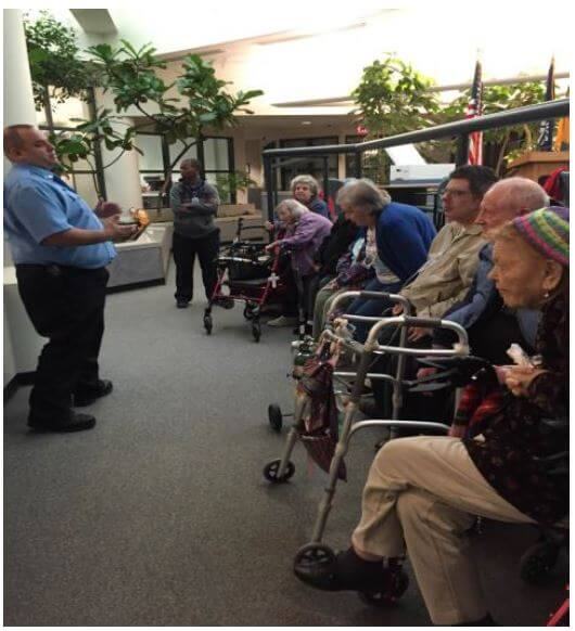 Woodcrest Commons residents  listen to a Henrietta firefighter talk at the Bailey Road station.