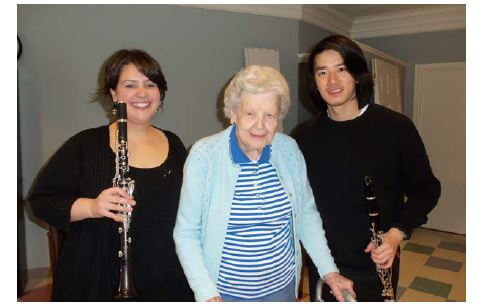 Eastman Clarinet Duo They are pictured here with Westwood Commons resident Hazel Conroy.