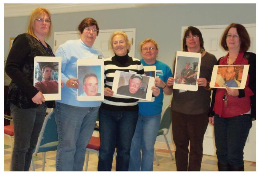 Westwood Commons staff members holding photos of their significant others