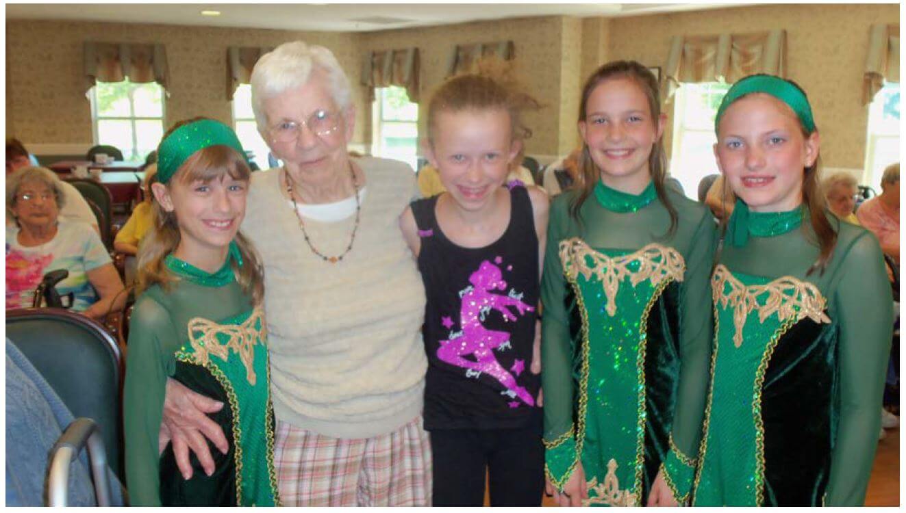 Westwood Commons resident Louise Ziegler poses with Spotlight dancers