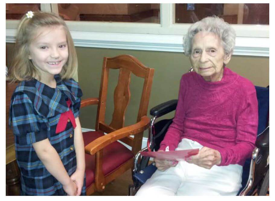 Southlake Christian Academy first-grader Annabeth Burgess presents Wexford House resident Lois Setzer with a Valentine’s Day card during a recent visit